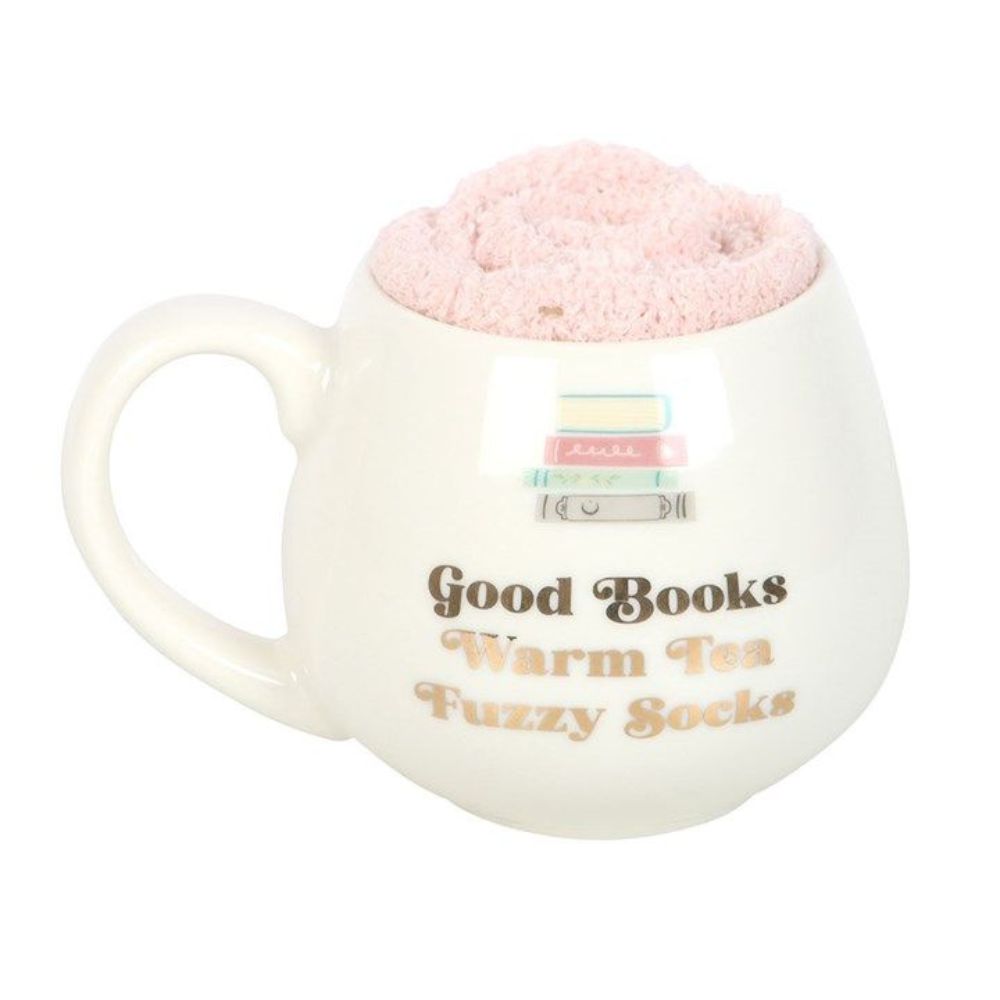White mug with pink fuzzy ball, text 'Good Books Warm Tea Fuzzy Socks' on a white background