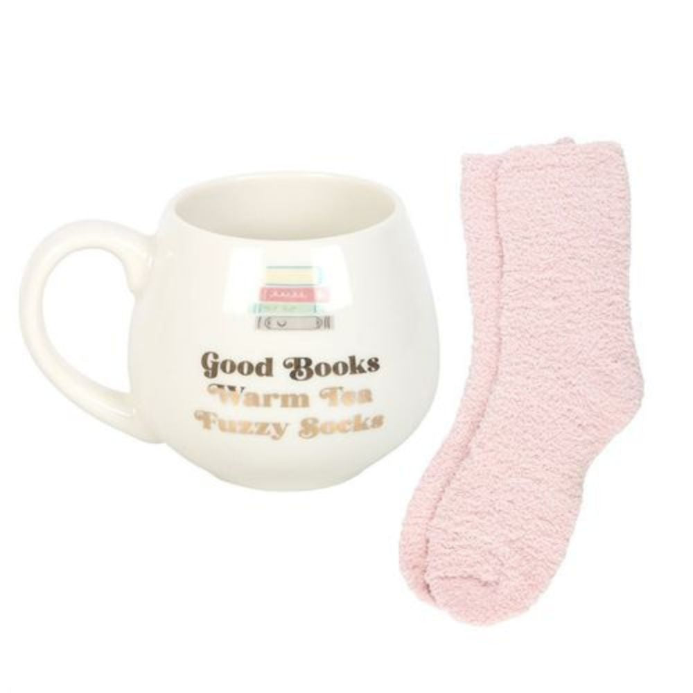 Mug with text 'Good Books Warm Tea Fuzzy Socks' and a pink sock on a white background