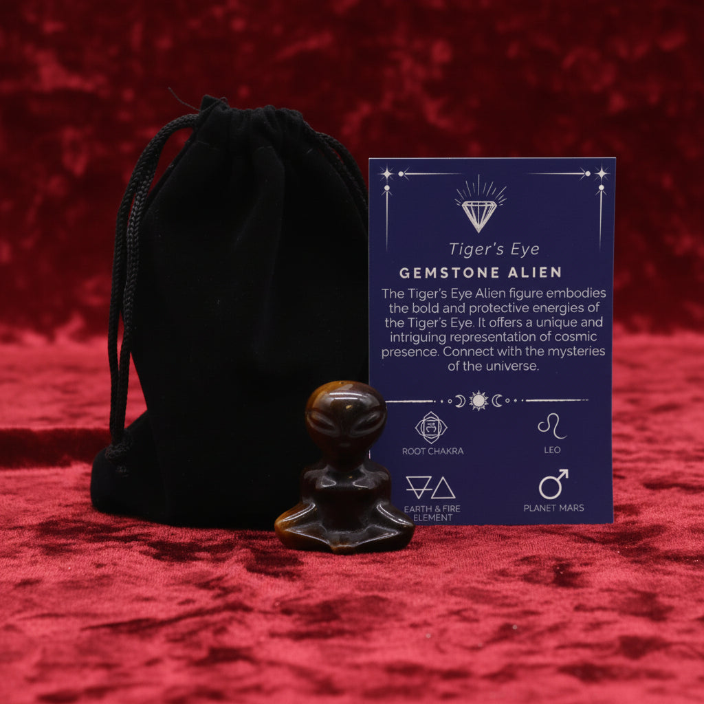 A hand-carved green gemstone figure shaped like an alien, accompanied by a black velvet pouch and a card detailing its properties.