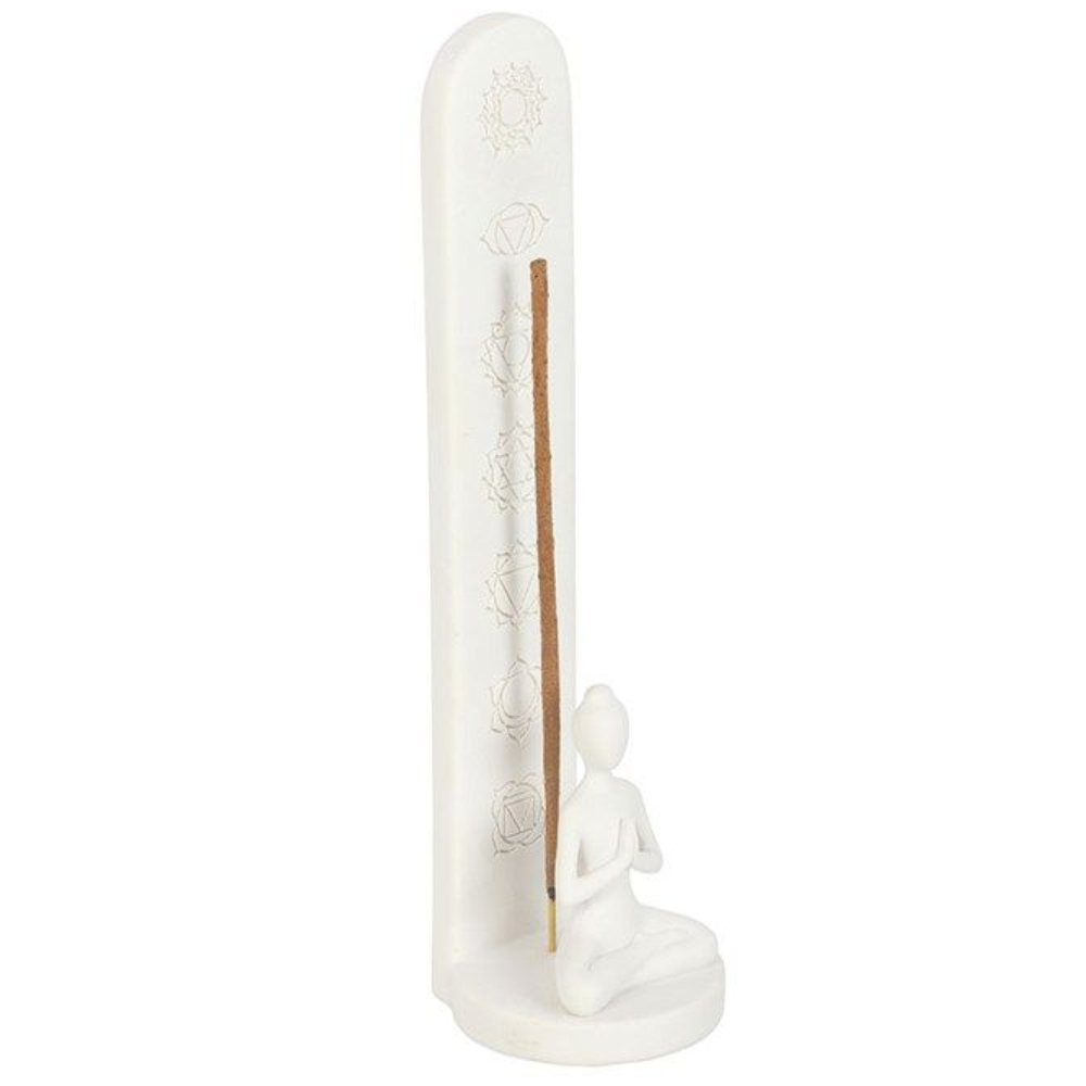 White ceramic incense holder with a small figure and incense stick on a white background