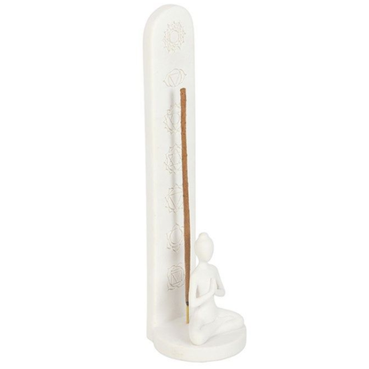 White ceramic incense holder with a small figure and incense stick on a white background