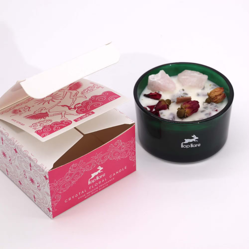 Black candle holder with decorative elements next to a pink box labeled 'Top Drawer'.