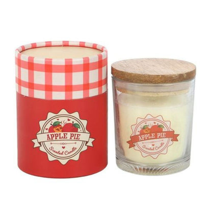 Candle with 'Apple Pie' label in a glass jar and red checkered lid, next to its packaging.