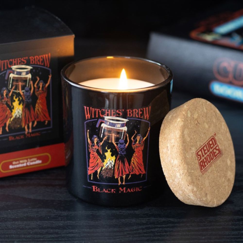 Witches' Brew Black Magic candle with decorative box and cork lid on a dark surface