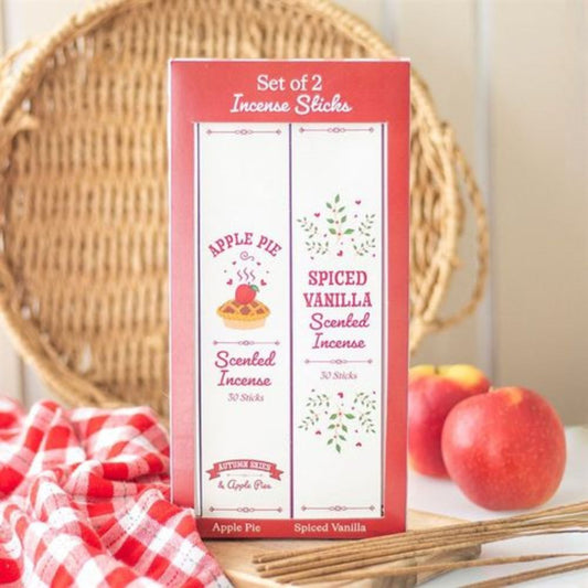 Set of 2 incense sticks packaging with apple pie and spiced vanilla scents, displayed with apples and a woven basket.