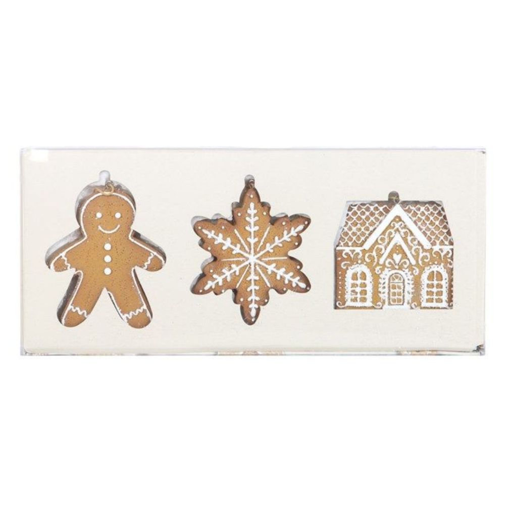 Decorative set of gingerbread man, snowflake, and house shapes on a white background
