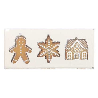 Decorative set of gingerbread man, snowflake, and house shapes on a white background