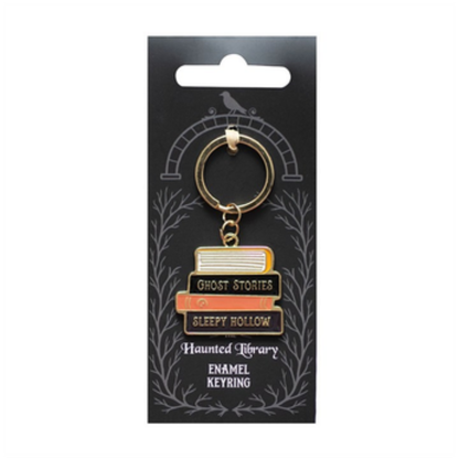 Keychain with book design on a black card with white text