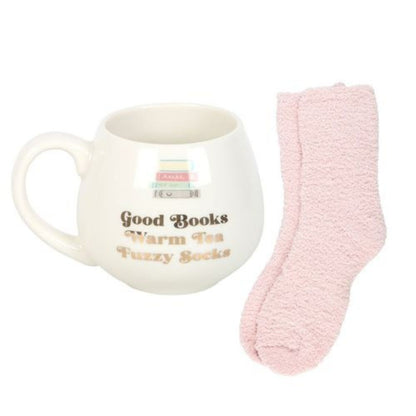 Mug with text 'Good Books Warm Tea Fuzzy Socks' and a pink sock on a white background