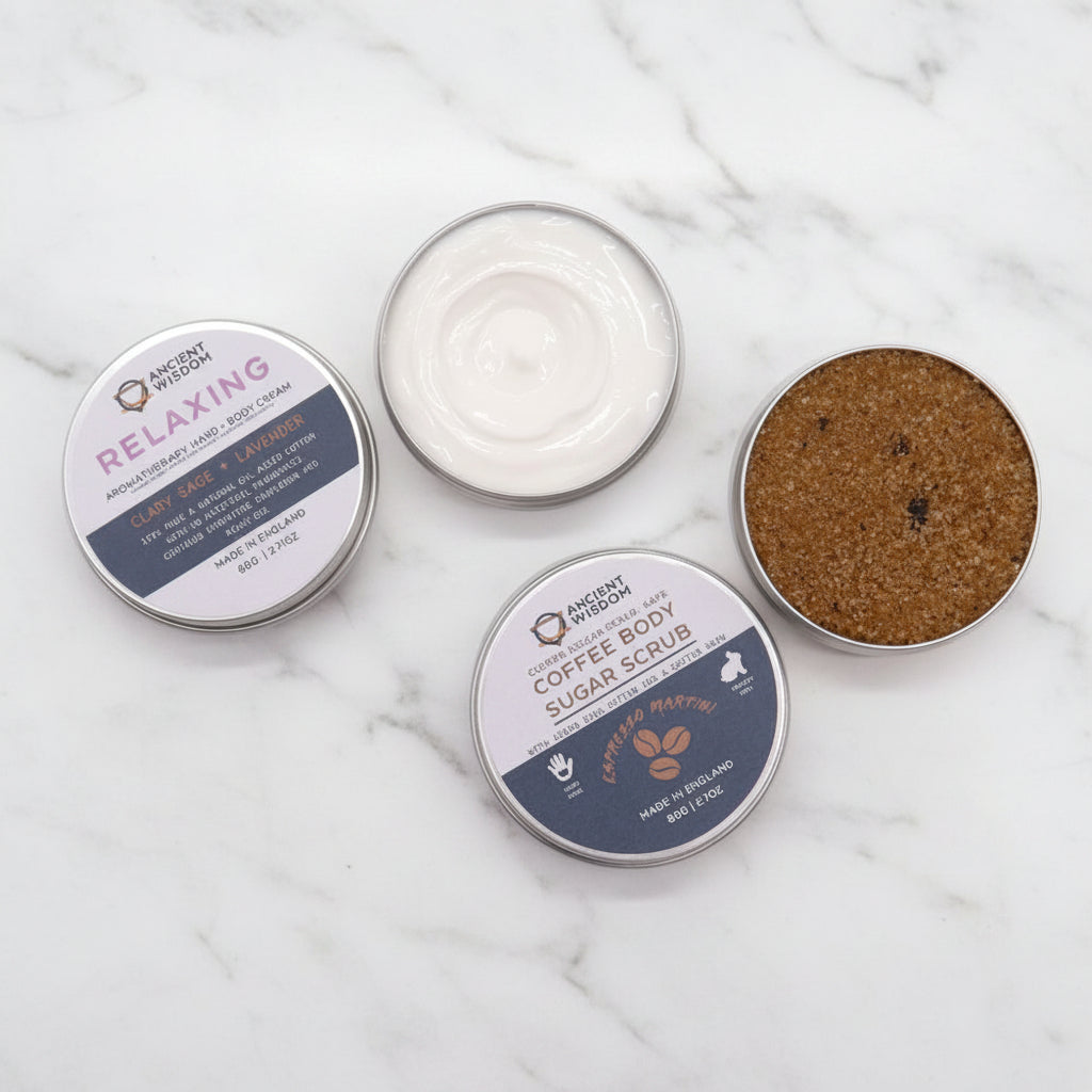 A self-care gift set box containing various bath products including a bottle, possibly of essential oil or perfume, and tubes with scrub and lotion.