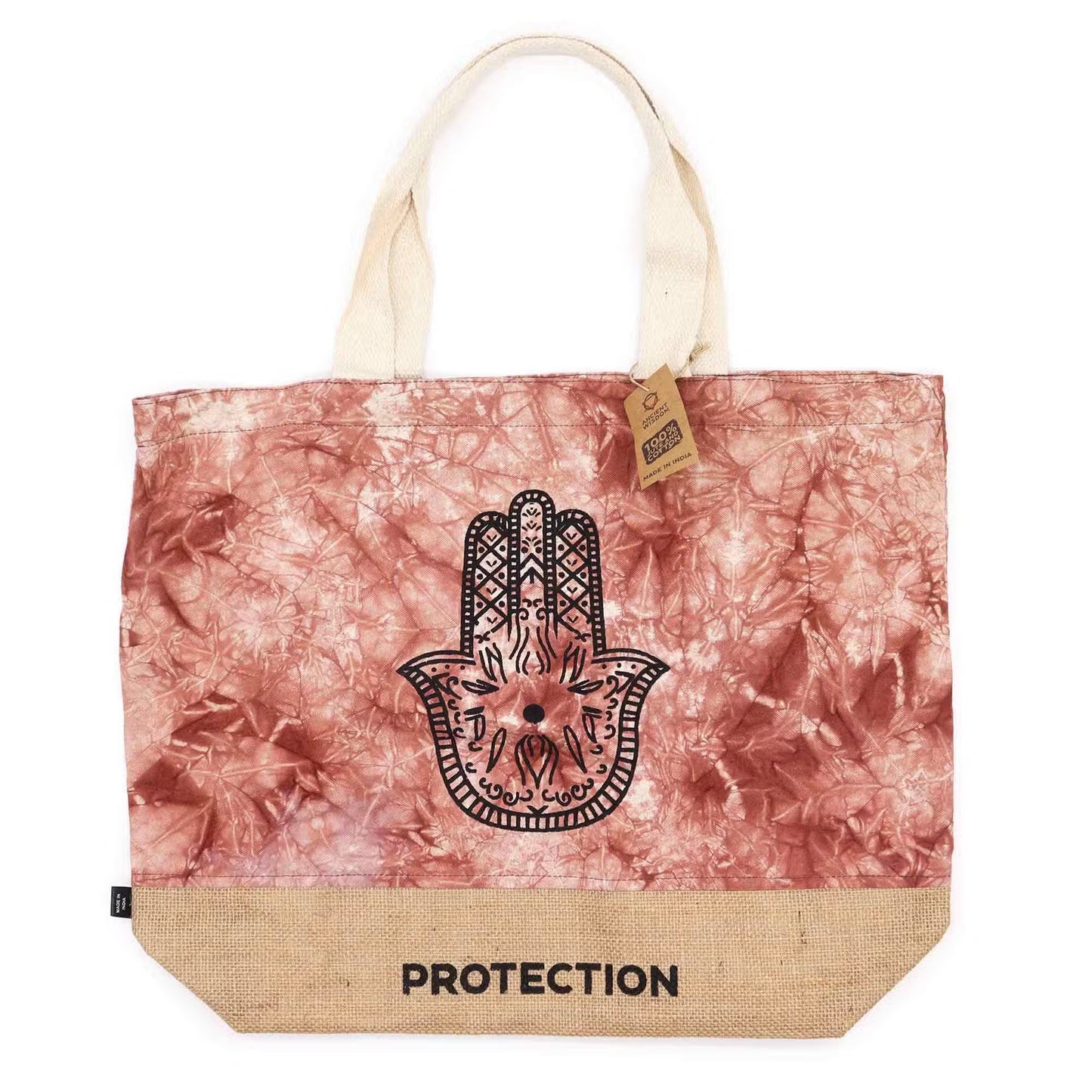 Tote bag with Hamsa hand design and 'PROTECTION' text on a pink and beige patterned background.